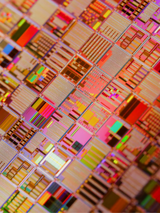 Close-up of a semiconductor wafer with multicoloured microchip patterns