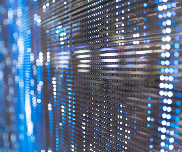 Close-up of server racks with blue and white indicator lights in a data centre