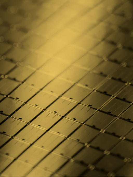 Close-up of solar cells arranged in a grid under warm golden light