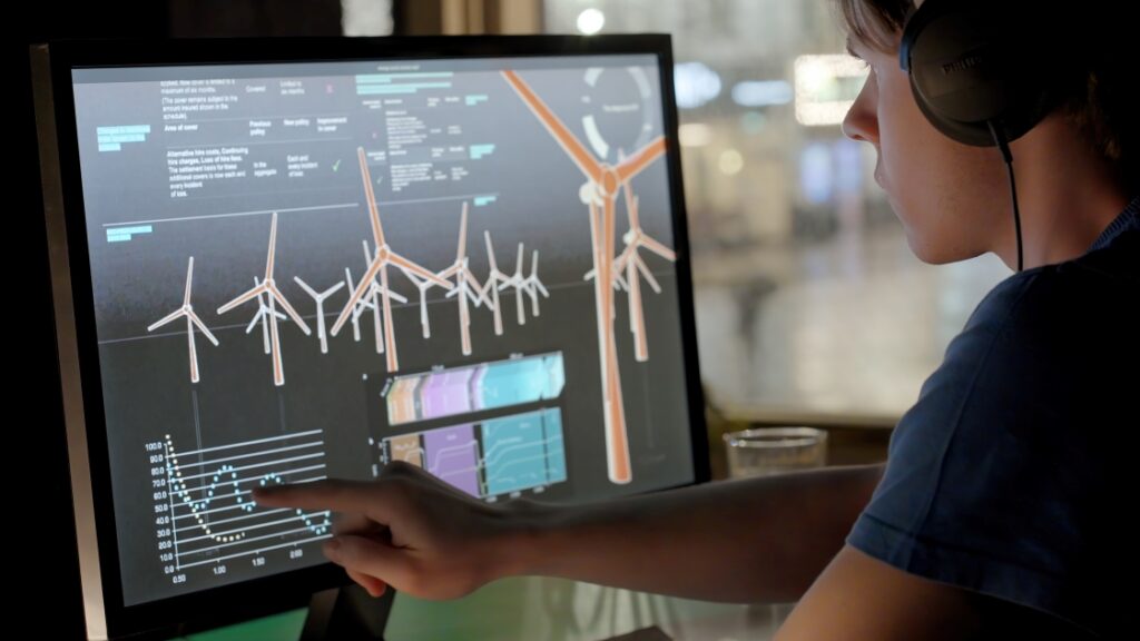 Person analysing energy data and wind power charts on a computer screen