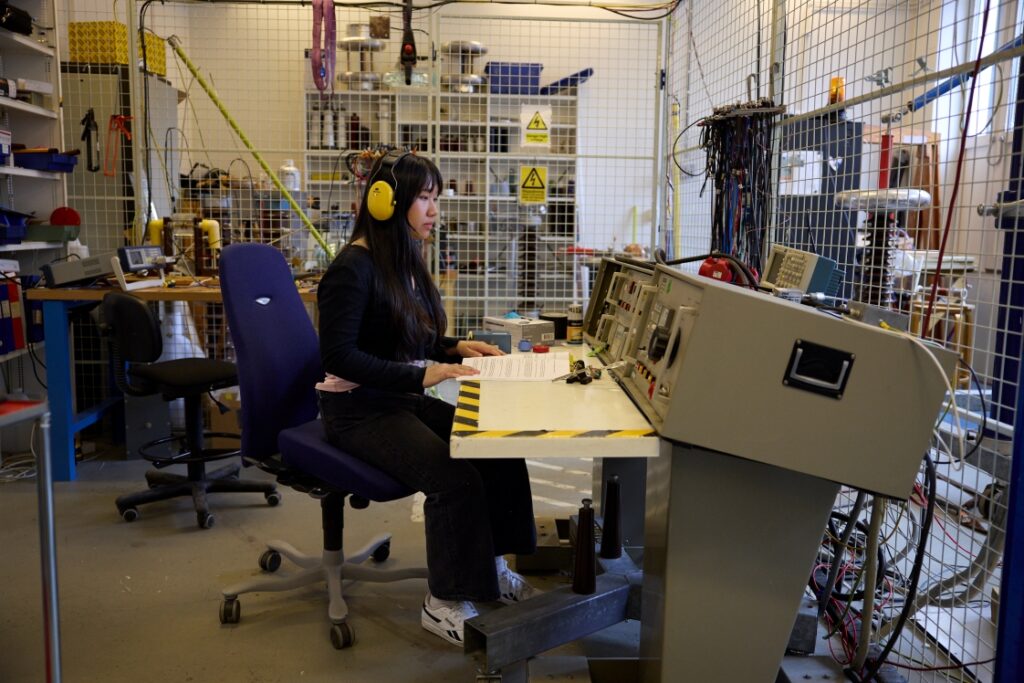 EMINE student working with engineering control equipment in a university laboratory