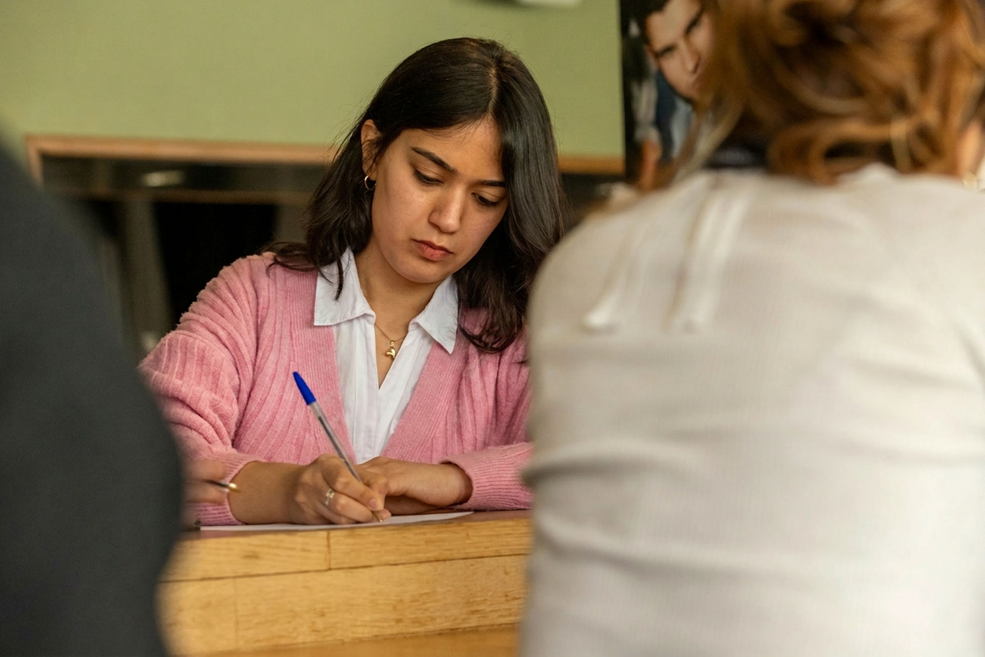 Masters+ student working at a desk