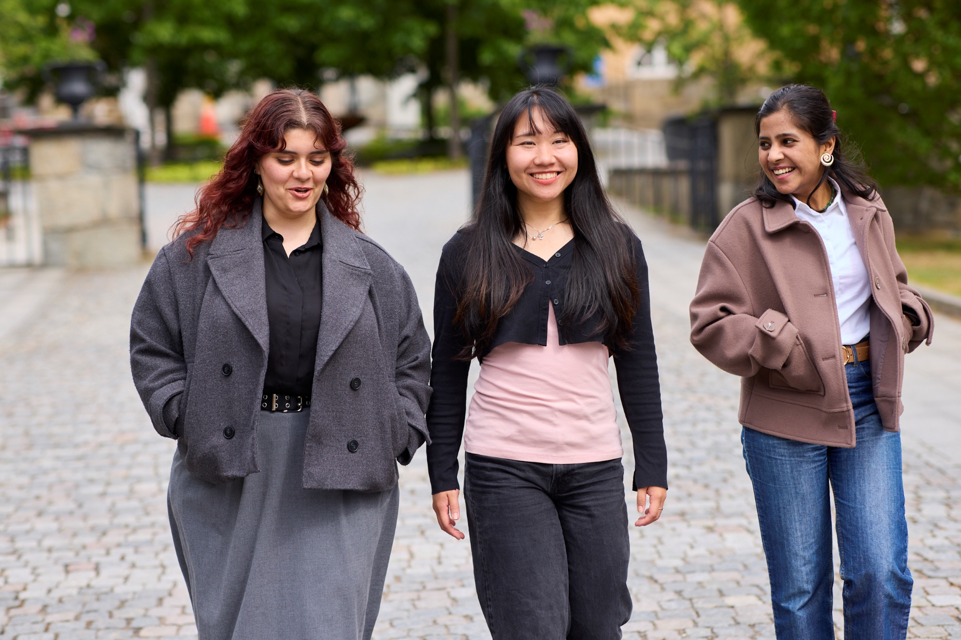 Three students walking together on a university campus