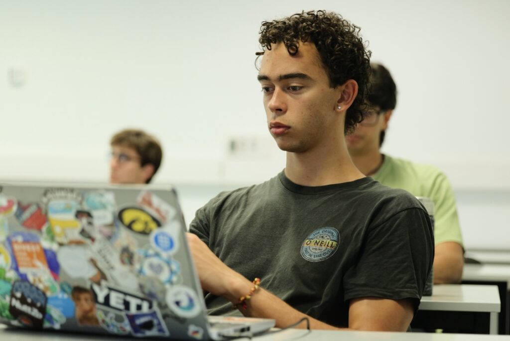 SENSE student working on a laptop during a university activity
